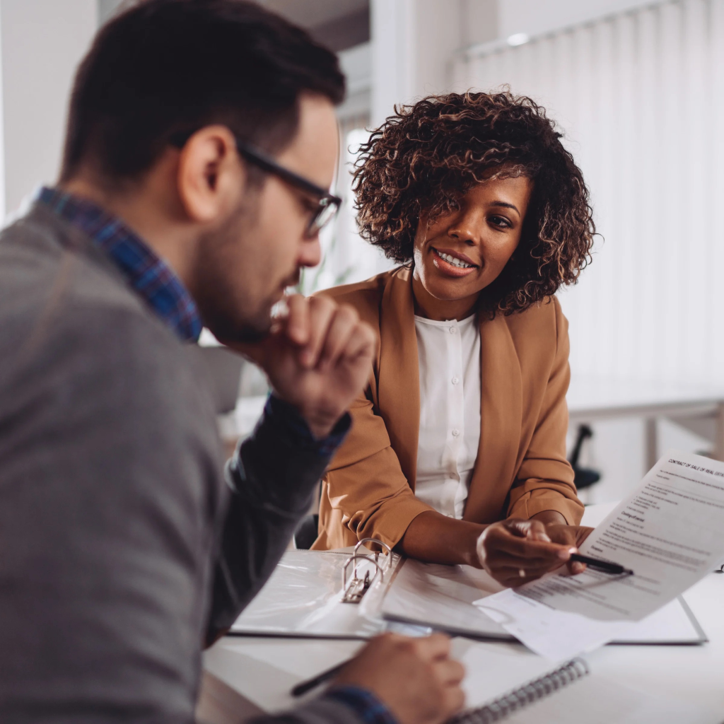 Tax advisor reviewing documents with a small business client during a planning meeting